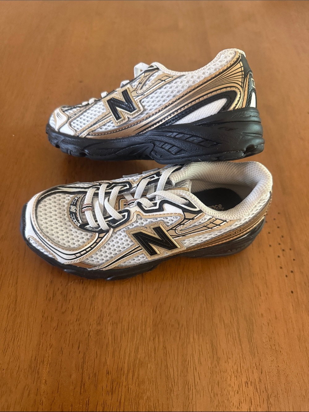 New Balance Kids White and Gold Athletic Sneakers with Black Soles